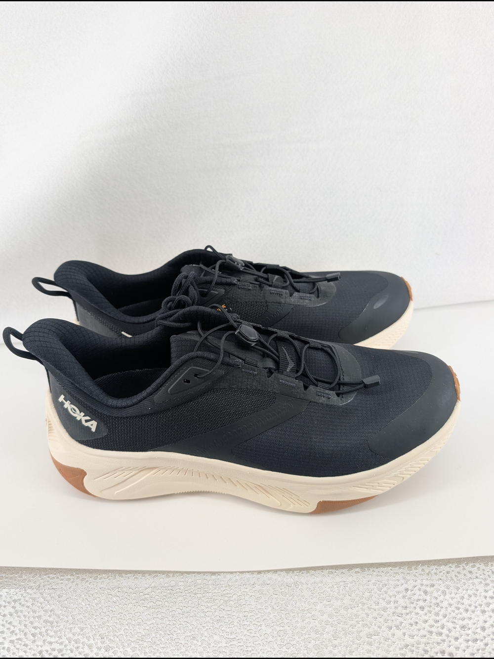 HOKA Transport 2 performance sneaker in a black and alabaster color